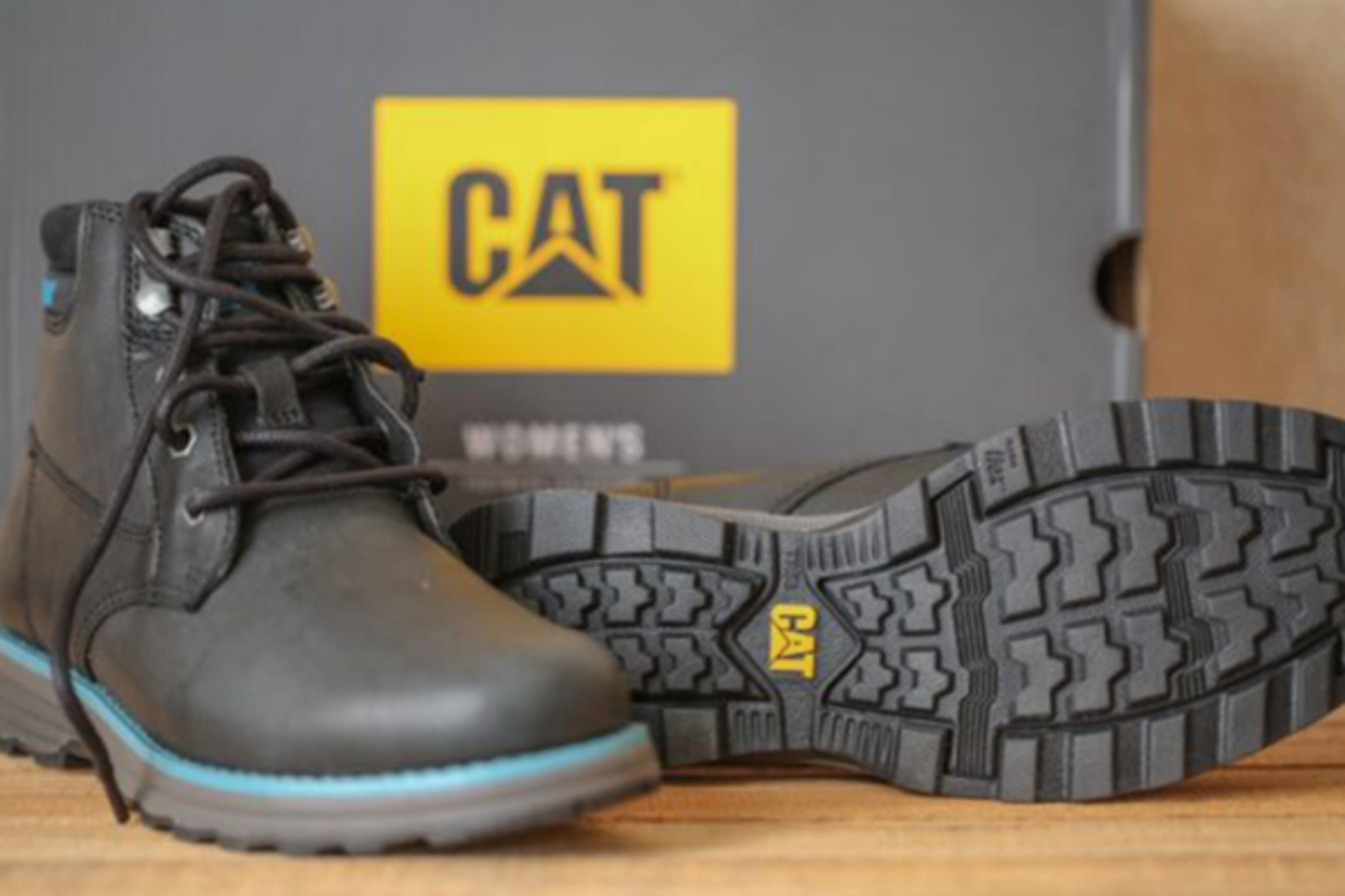 One black, lace-up Caterpillar brand women's work boot and its sole, with the box in the background.