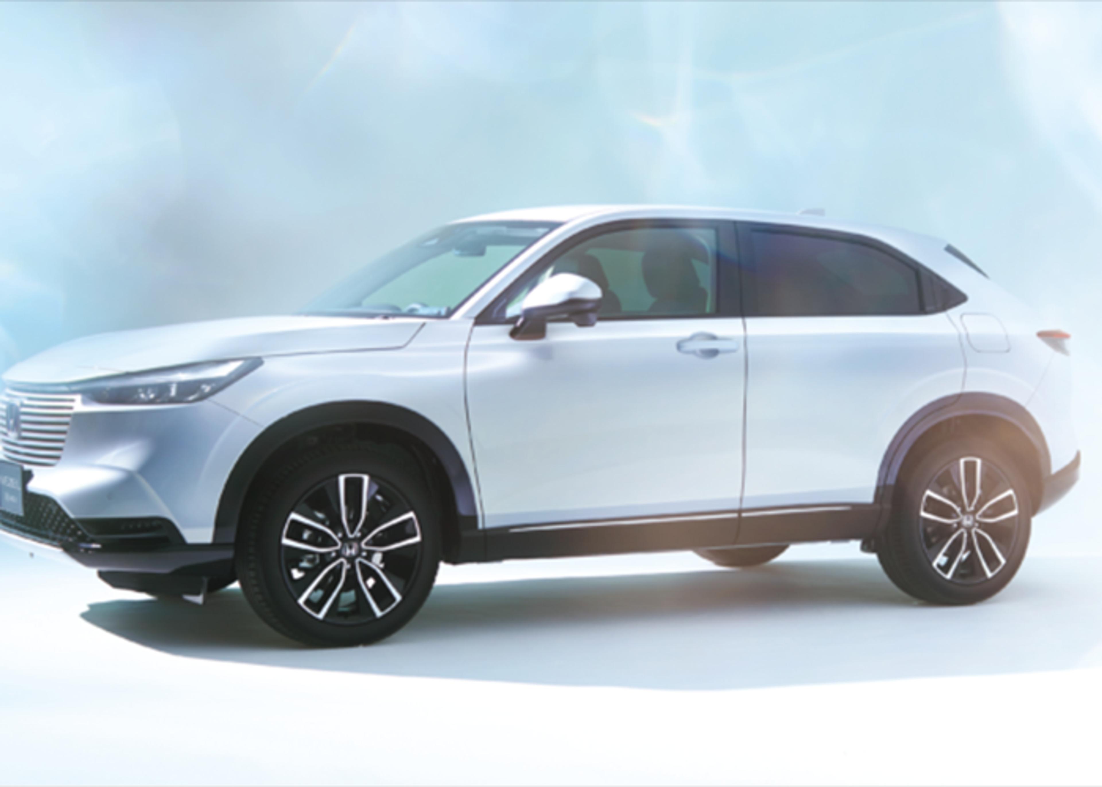 Close-up of a white Honda vehicle, showcasing its front-end design and wheel detail.