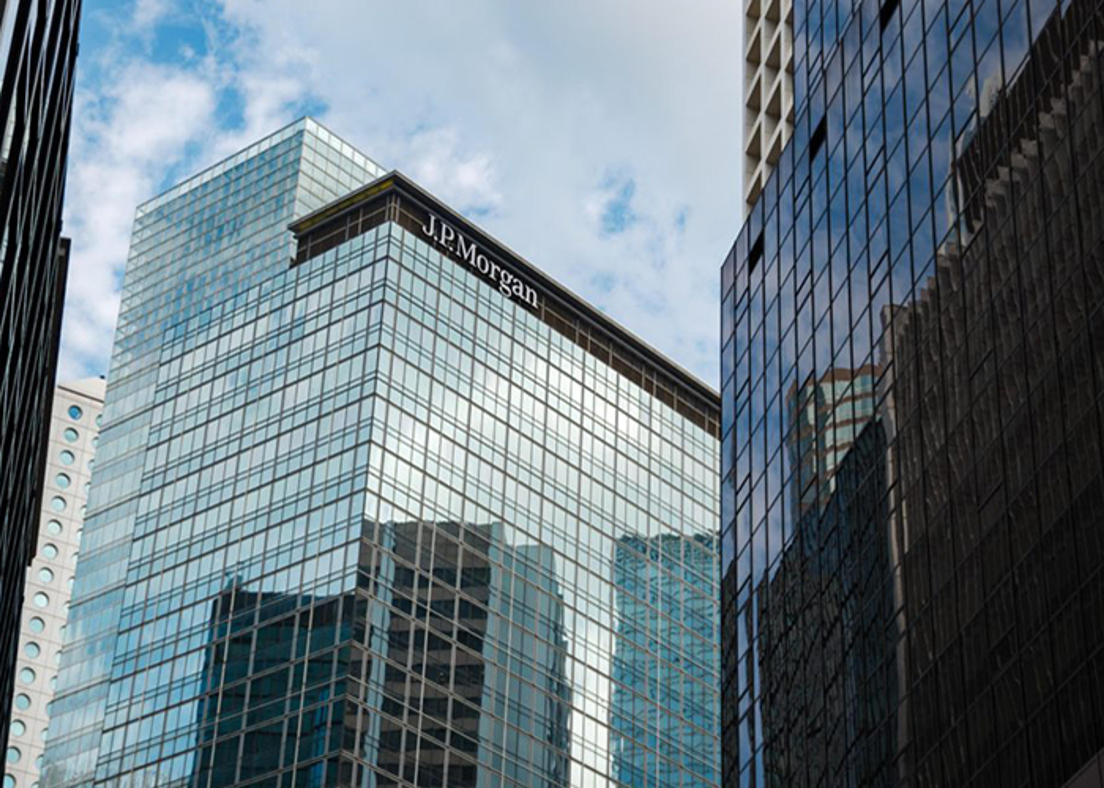 Exterior view of a J.P. Morgan corporate office building with a glass facade and the company name displayed at the top.
