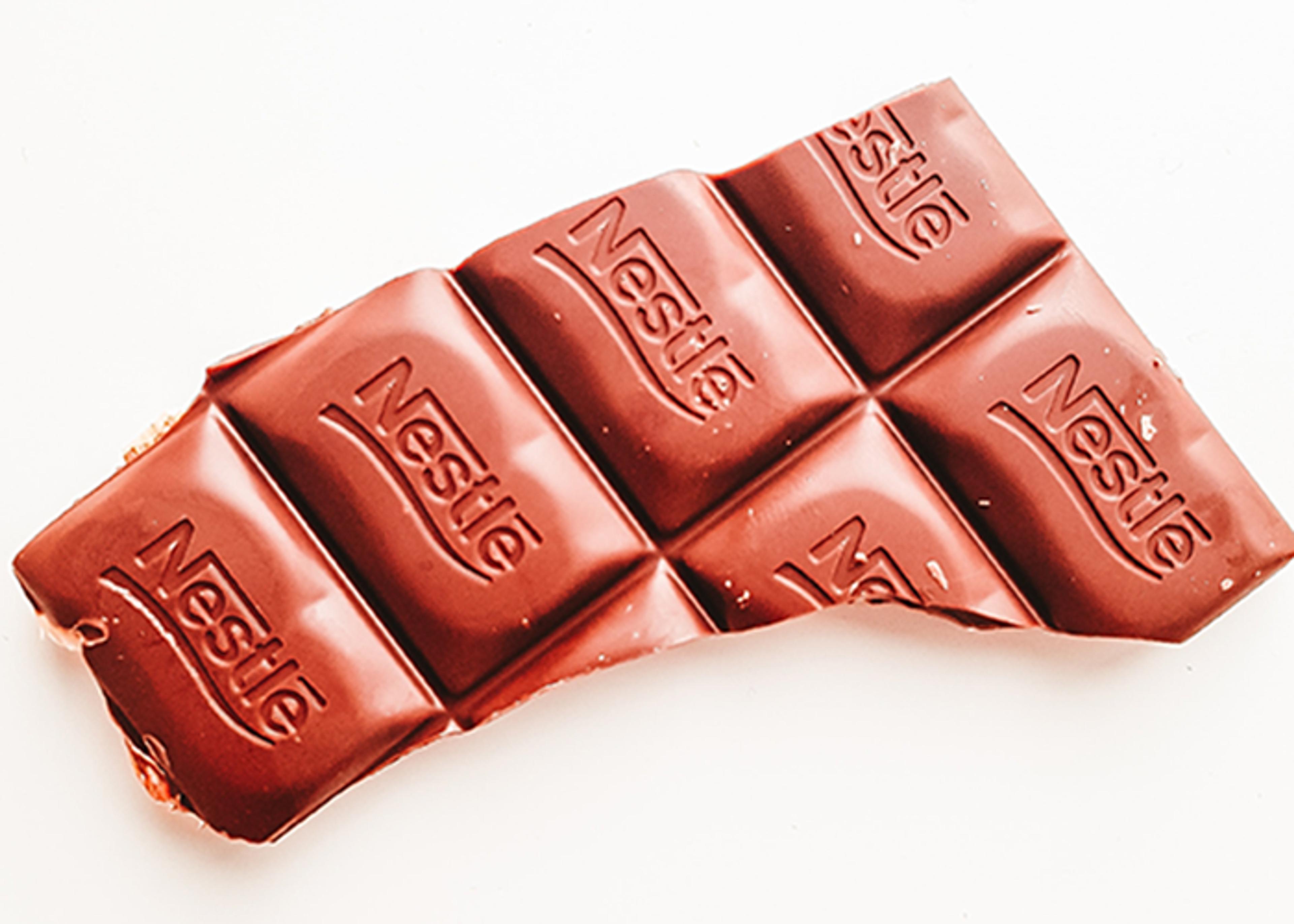 Partially unwrapped Nestle chocolate bar with rectangular segments.