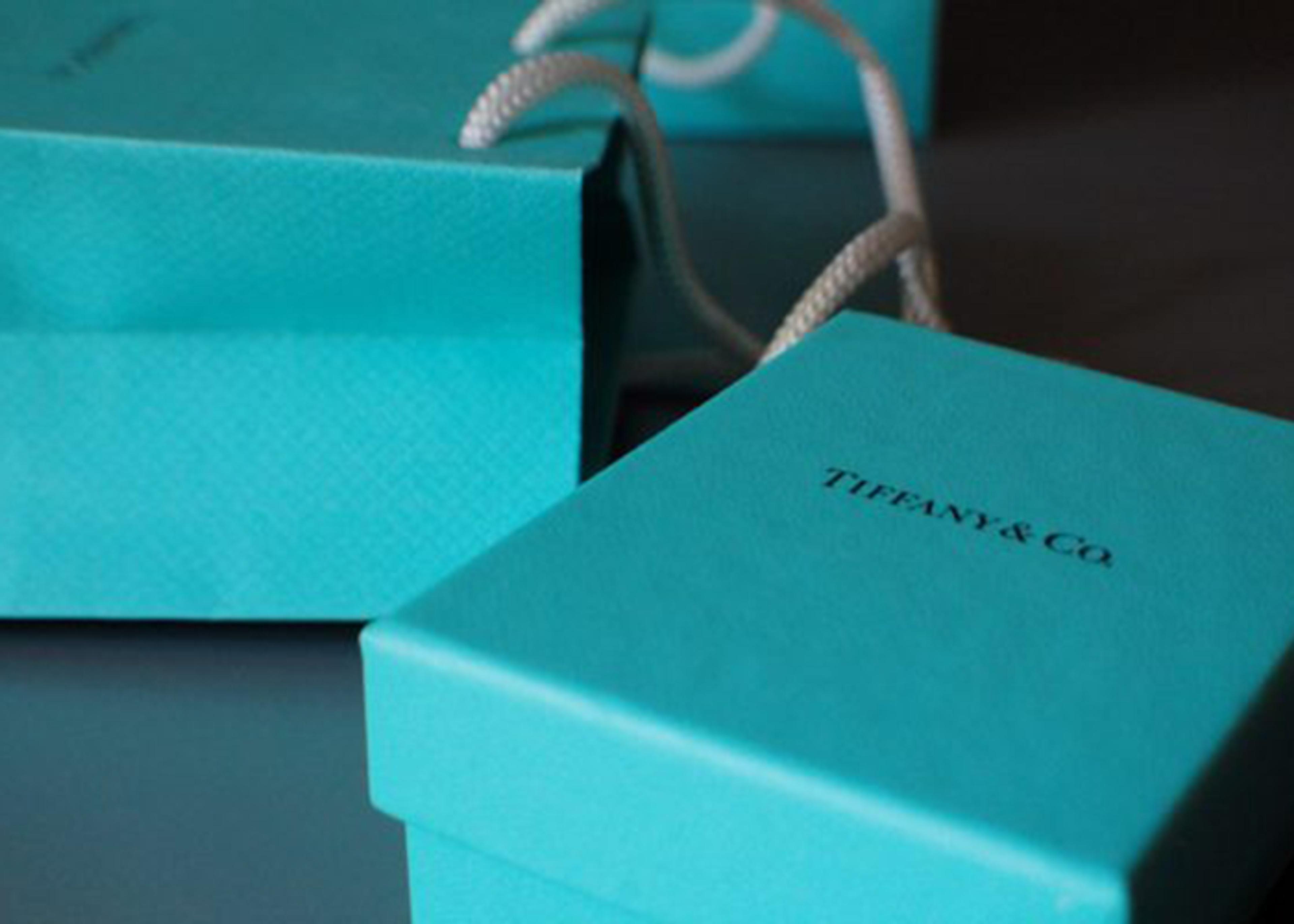 Close-up of a Tiffany & Co. box and shopping bag, both in the brand's signature robin's egg blue.