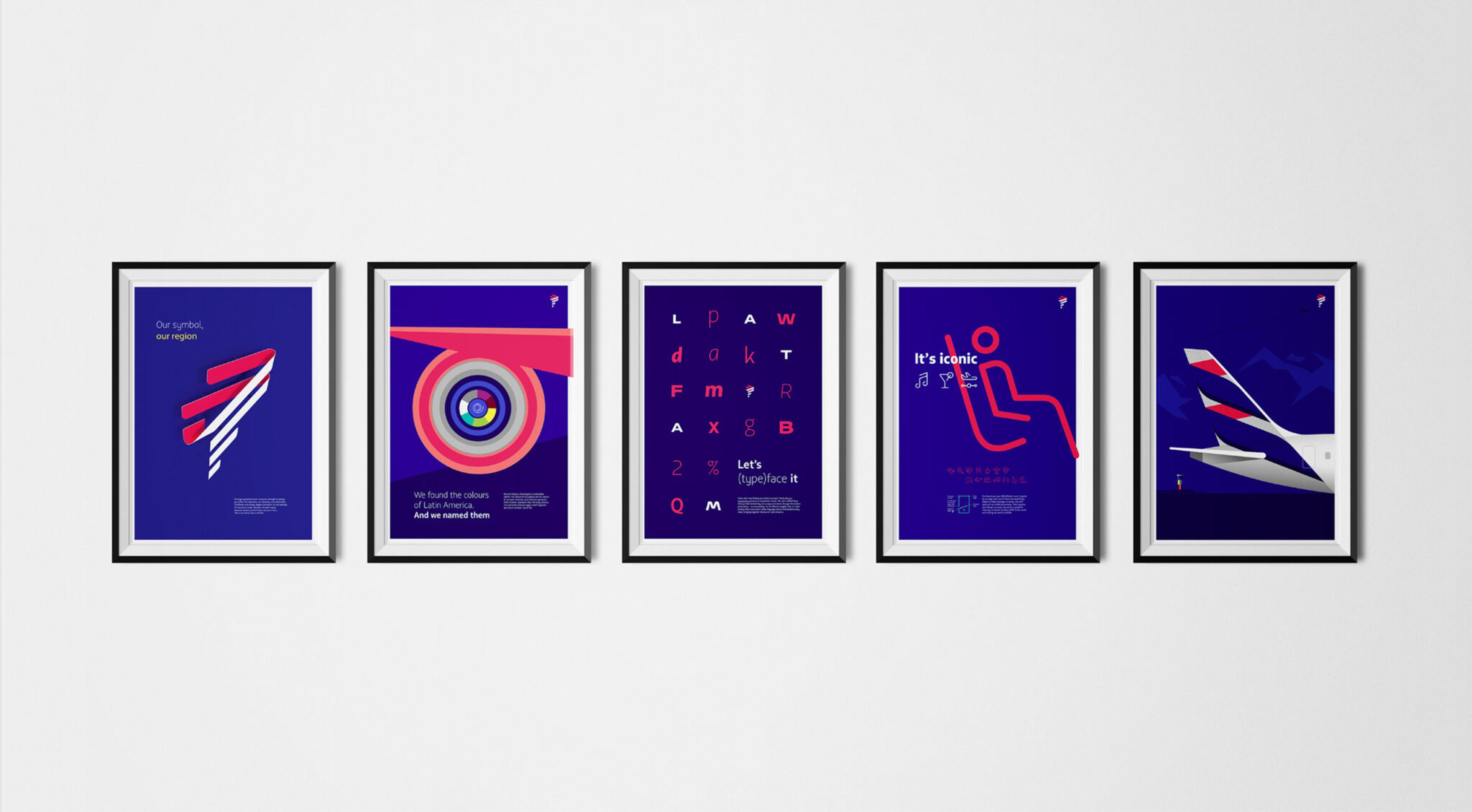 Five framed graphic design posters are aligned in a row on a white wall. Each poster has a black frame and a predominantly blue background, featuring colorful abstract and minimalist designs that incorporate text.