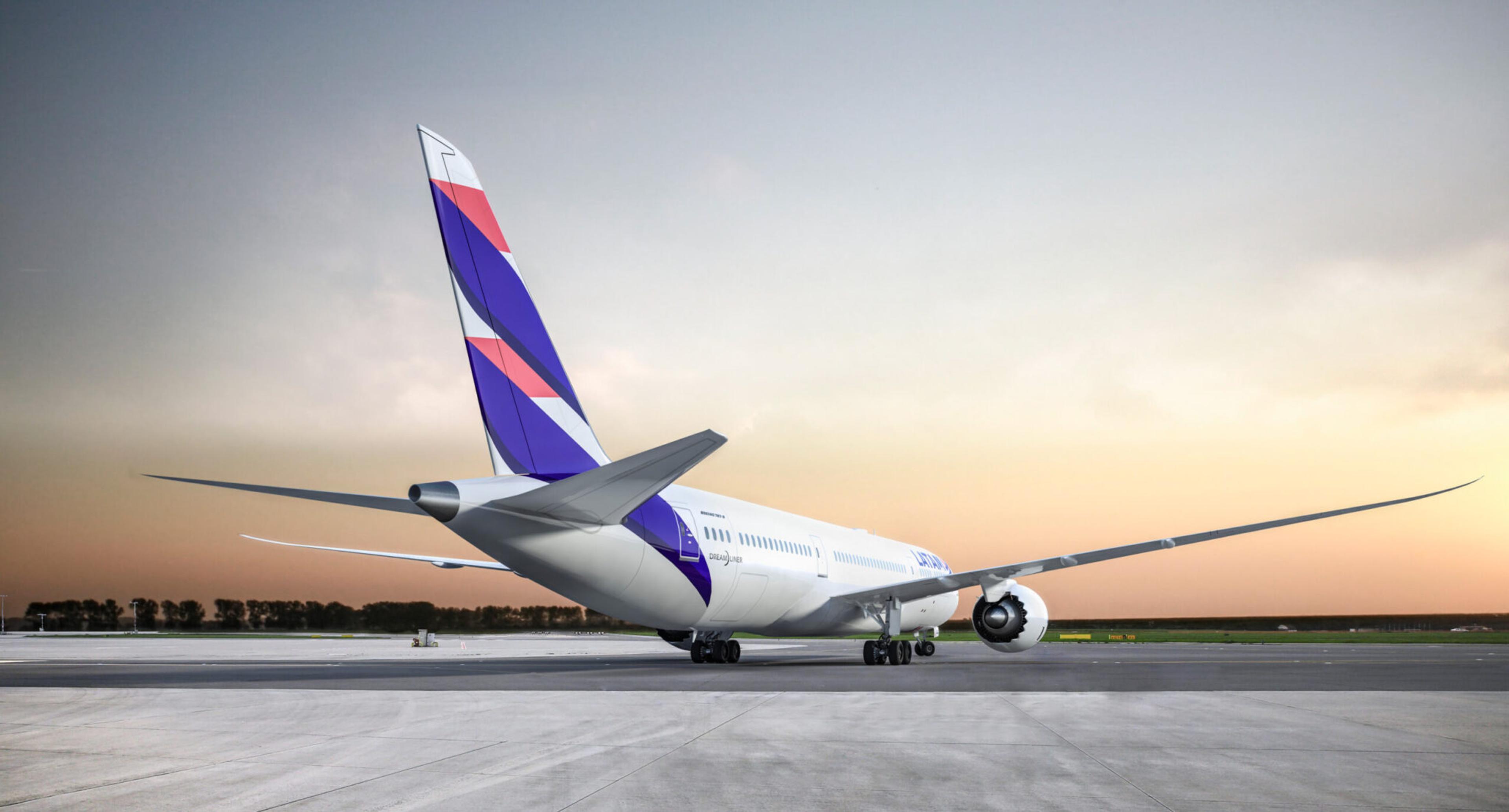 A LATAM Airlines Boeing 787-9 Dreamliner rests on a concrete runway at dusk, the plane's tail featuring a white top, and stripes of red, white, and purple.